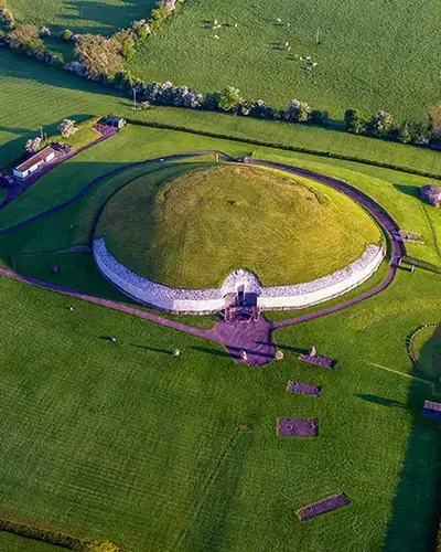 Aerial view of Newgrange with its white quartz facade in the Boyne Valley